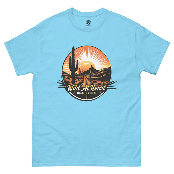 Light blue Western T-shirt with “Wild at Heart Desert Vibes” desert road and cactus graphic.
