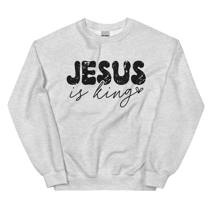 Ash grey Christian sweatshirt with Jesus Is King text on the front, laid flat on a neutral background.