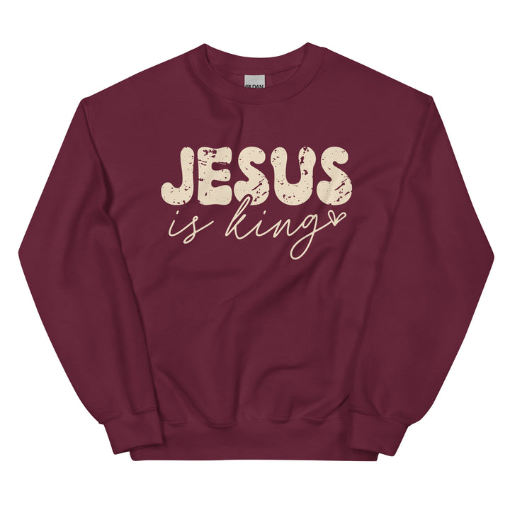 Maroon Christian sweatshirt with Jesus Is King text on the front, laid flat on a neutral background.