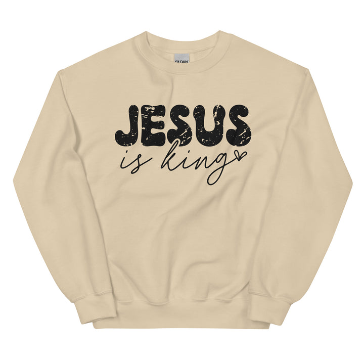 Sand Christian sweatshirt with Jesus Is King text on the front, laid flat on a neutral background.
