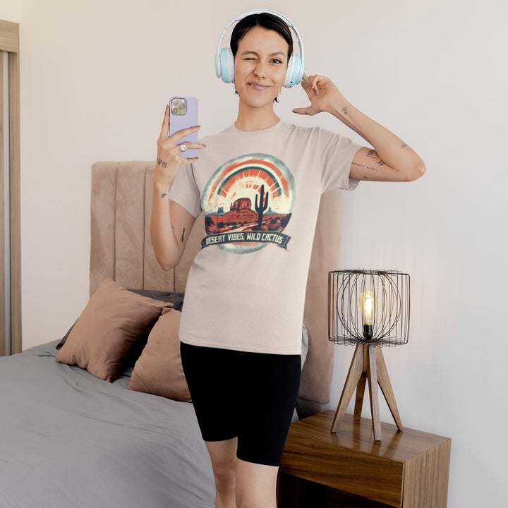 Woman wearing a beige Western T-shirt with “Desert Vibes Wild Cactus” desert rainbow cactus graphic.
